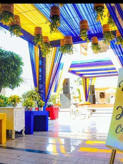 Another view of the blue and yellow Haldi entrance, showing the custom welcome sign and colorful furniture.
