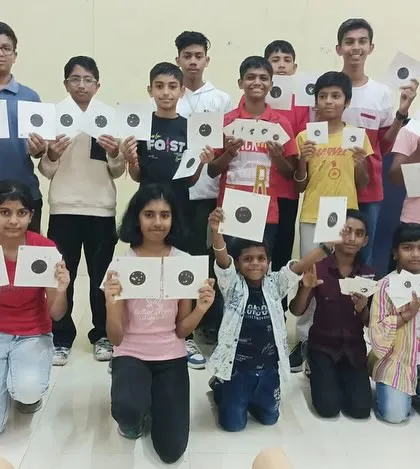 A full group photo of students and an instructor after a fun and productive workshop, with everyone holding up their practice targets.