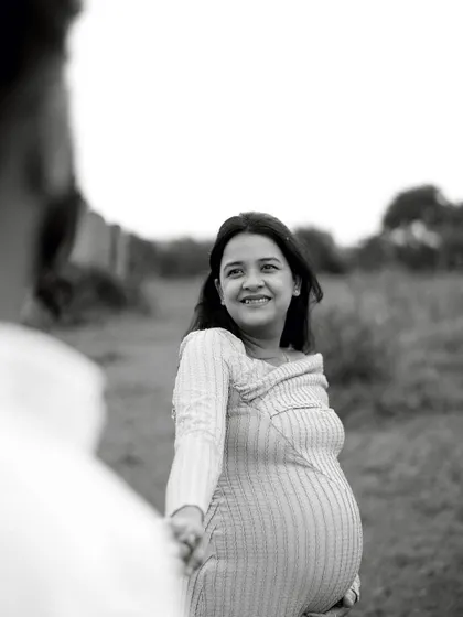 A classic black and white "follow me" shot, capturing her joyful expression as she leads him. The over-the-shoulder perspective creates a personal and engaging feel.