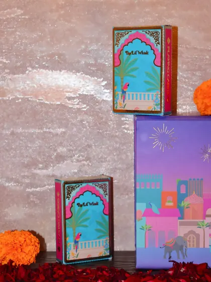 Our custom playing cards displayed with other festive elements. They are designed to complement our Diwali hampers and add an element of fun to your celebrations.