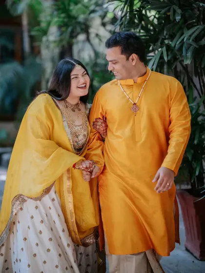 A portrait of the couple during their Haldi ceremony. Ridhi and Prashanth glittered in "yellove" amidst the greenery theme we tailored for them, using the venue's rustic charm as the perfect backdrop.