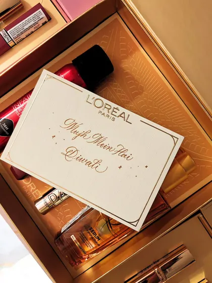 The final personalized card, "Mujh Mein Hai Diwali," nestled in a L'Oréal gift box. It’s about creating a complete, beautiful experience from the product to the packaging.