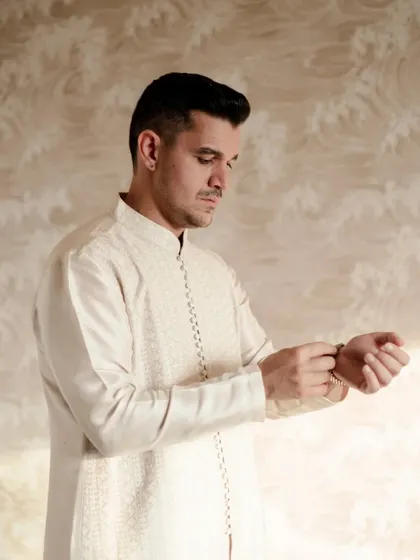 The groom getting ready for his Kashmiri wedding, a quiet moment of preparation and anticipation.