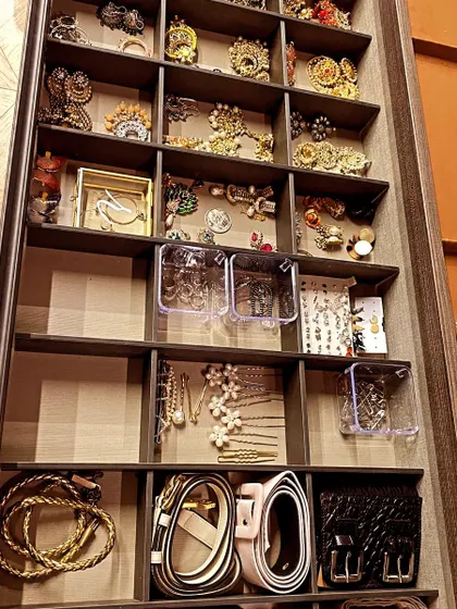 A drawer organized with accessories like belts and jewelry. Using built-in dividers or small bins helps to create a dedicated spot for every small item.