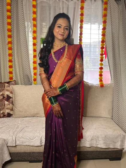 Kritika's engagement look in a traditional purple and red saree.