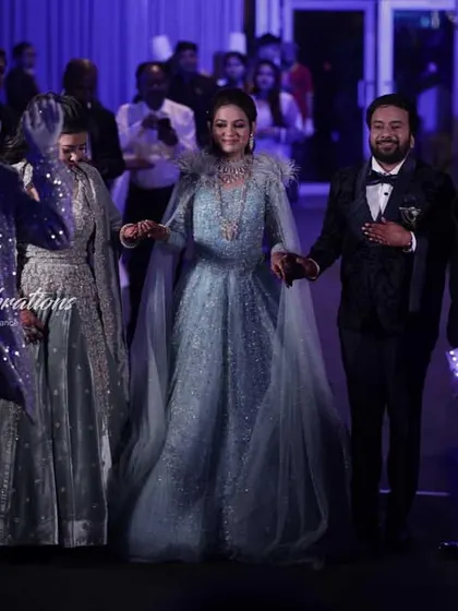 The couple makes their grand entrance, hand-in-hand, through a pathway of futuristic performers. This type of entry is perfect for a glamorous cocktail or sangeet night.