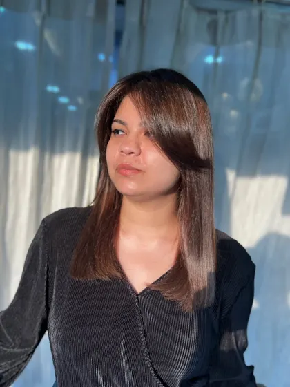 A dreamy transformation blending warmth, depth, and shine. This client's hair is glowing in the sunlight.