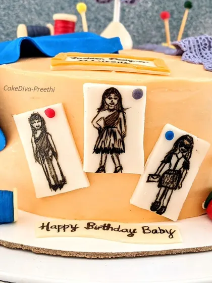 A close-up of the hand-drawn fashion sketches on the fashion designer cake. I love adding these small, personalized details that make a cake truly unique.