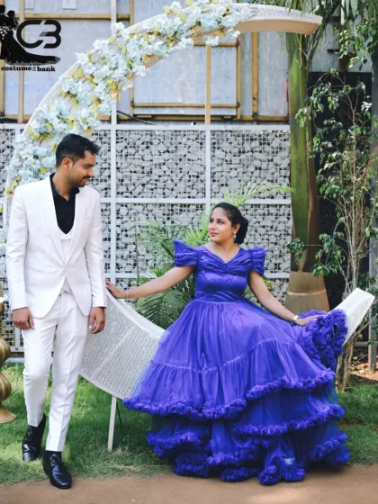 A fairytale pre-wedding shoot at my indoor studio. The groom's sharp white suit and the bride's voluminous blue gown, both available for rent, create a magical scene against our moon prop.
