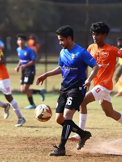 An intense moment from our MFA Third Division match against Mumbai Strikers. A player skillfully dribbles the ball under pressure from an opponent.