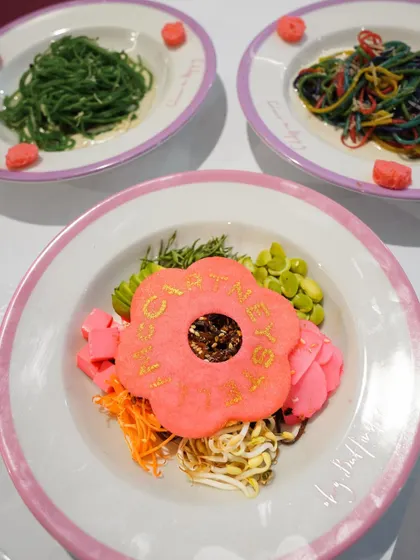 A colorful grain bowl from the Ajio Luxe Café, topped with an edible flower-stamped cracker. We believe every dish should be an opportunity for branding and beautiful design.