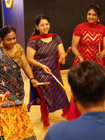 An instructor giving personal guidance during a group practice. We provide individual attention to ensure everyone is comfortable with the steps.