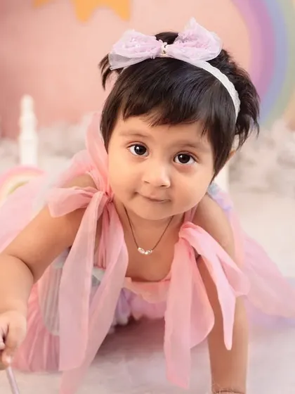 A close-up of this little fairy in her rainbow-themed wonderland. The soft pastel colors and dreamy props like her magic wand make for truly magical portraits.