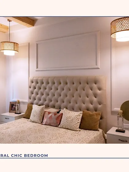 A neutral chic bedroom that exudes calmness. The deeply tufted headboard creates a soft, luxurious focal point, complemented by wall moldings and warm, layered lighting from the woven pendant lamps.