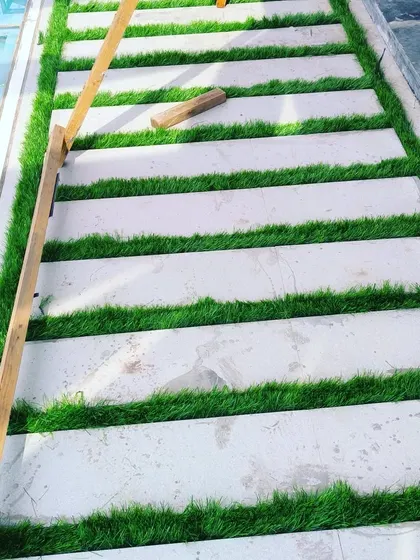 A close-up of the pathway we created. The 50mm grass is thick and stands up well, creating a neat border against the stone slabs.