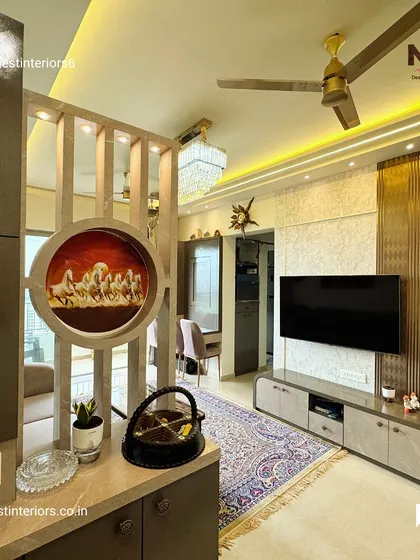 Here, a wooden partition with a circular cutout art piece separates the living and dining areas without closing off the space. It adds an artistic element while maintaining an open feel.