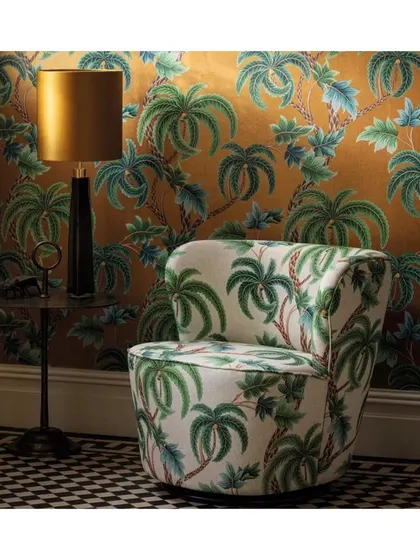 Tropical prints bring life and character into any home. Here, a palm-print wallpaper and matching armchair upholstery create an immersive, verdant escape. I can source a wide array of tropical and floral designs to suit your vision.