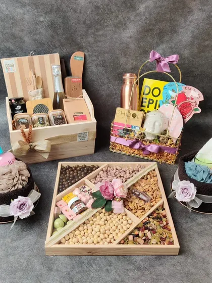 Not sure what to gift for a housewarming? We can help. This image shows a collection of housewarming hampers we created, including dry fruit platters and home spa kits.