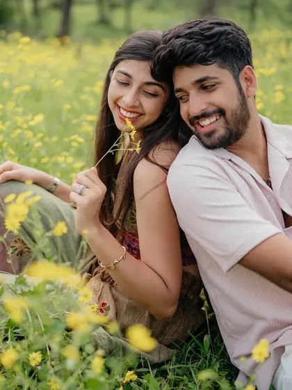 She playfully holds a flower while they share a happy moment. It’s the little interactions that make a pre-wedding shoot feel personal.