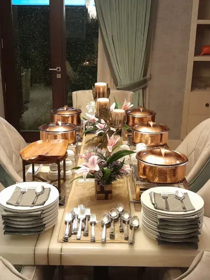 An elegantly set table for an intimate party, showcasing my copper serveware and attention to detail in presentation.