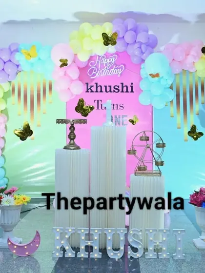 A pastel butterfly theme with a beautiful balloon arch and light-up letters.