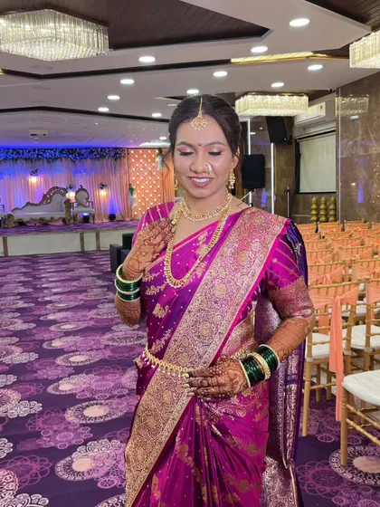 This bride radiates pure grace in her vibrant purple saree. Her wedding look was crafted to be uniquely hers, blending timeless beauty with personal touches that reflect her calm and confident personality.