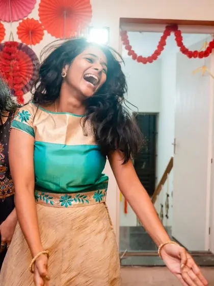 A candid shot of pure laughter and joy on the dance floor. Our goal is to create an environment where everyone feels free to express themselves and have the time of their lives.