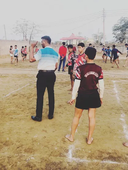 Coaching is about teaching and guiding. Here I am on the ground, instructing our young players on the fundamentals of the game.