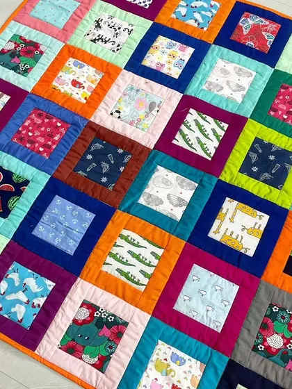 An angled view of the window pane baby quilt, showing its soft and fluffy texture.