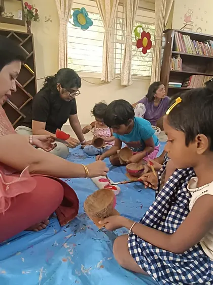 A close up of the coconut shell painting in progress. This activity uses natural materials and encourages resourcefulness.