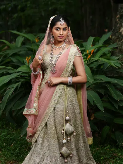 A full-length shot showing how the pastel jewellery set complements the elegant lehenga, creating a dreamy and cohesive bridal look.