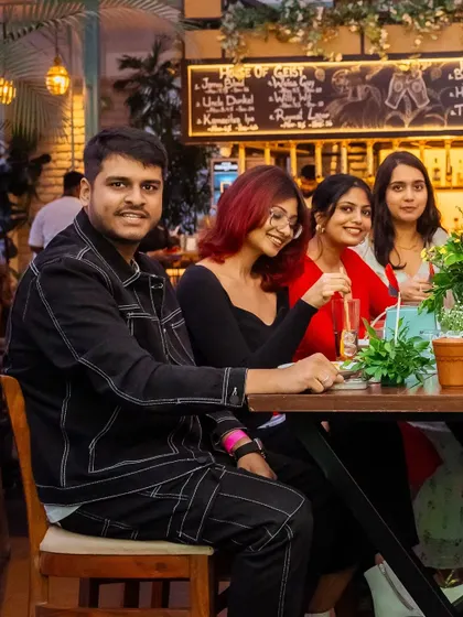 Friends gathered around a table near the bar. The vibrant energy of the bar area is perfect for social gatherings and celebrations.