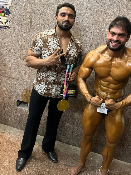 Celebrating a client's gold medal win. My virtual muscle gain programs are designed to build champions.