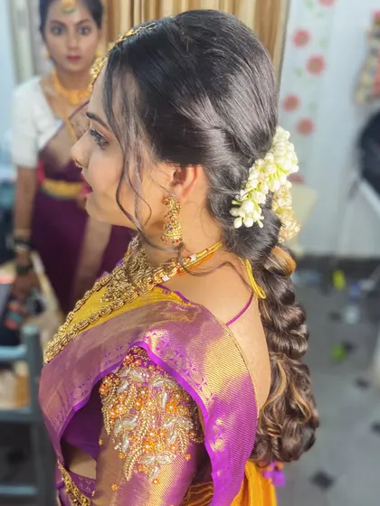 Another angle of the romantic side-swept curly hairstyle, perfect for a reception.