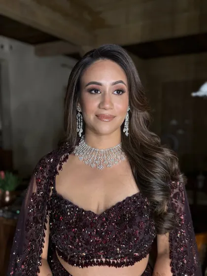 This portrait showcases the complete look in a different lighting. The makeup remains flawless and radiant, proving its durability and photogenic quality throughout the night.
