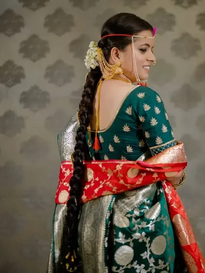 A beautiful shot of the bride from the back, showing her traditional hairstyle and saree.