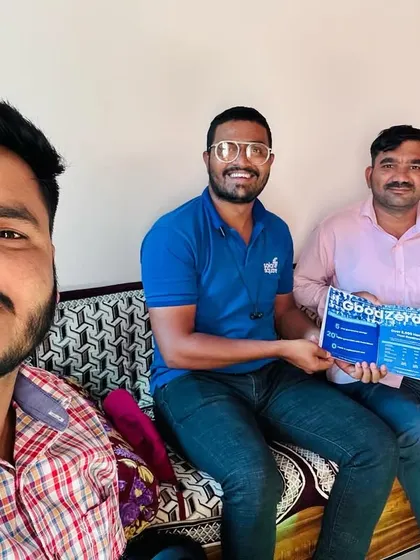 Our team member takes a selfie with a customer holding our "GoodZero" brochure. Guaranteed savings and peace of mind.