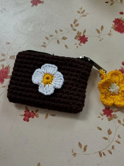 Two of our floral mini wallets, showing different flower designs and charms.