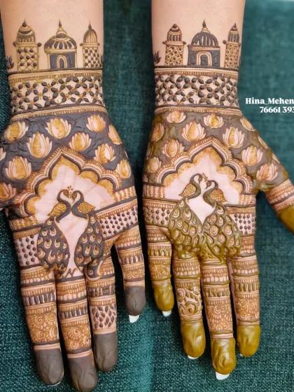 Another view of the peacock and temple design, showing the fresh henna paste on one hand and the semi-dry paste on the other.