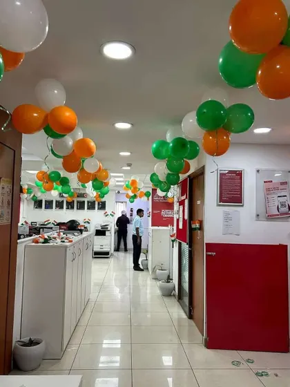 An office corridor decorated with tricolor balloon bunches for Independence Day.