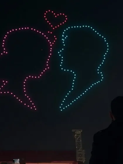 Guests watch as silhouettes of a couple, joined by a heart, light up the sky. This is the kind of romantic, picture-perfect moment we love to create for weddings and receptions.