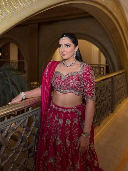 Another view of this stunning rani pink lehenga look. The shimmery smokey eyes are accentuated with a wing liner, and finished with nude pink lips for a balanced, glamorous look.