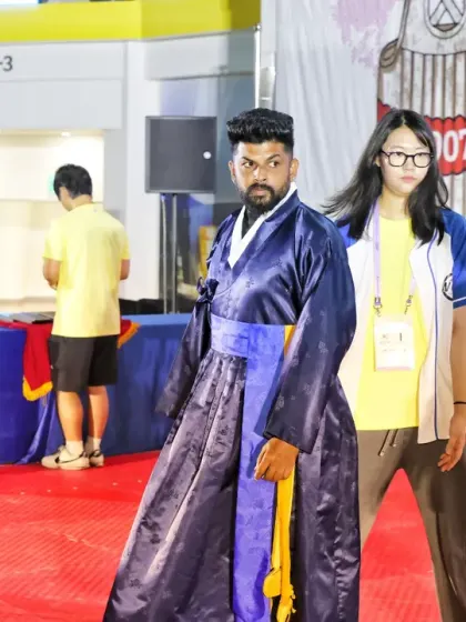 Walking on the red carpet in traditional Korean attire during the opening ceremony.
