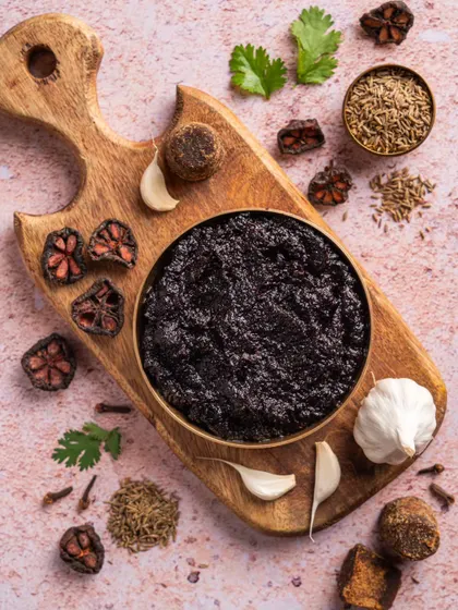 A deconstructed shot of the ingredients used in Aazol's chutney, like kokum, garlic, and spices. This highlights the natural and authentic components of the product.