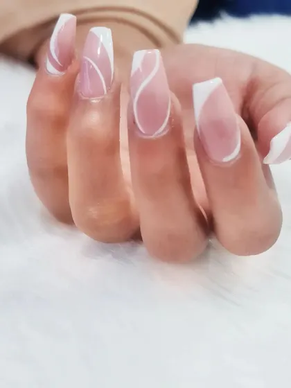 Elegant and modern, this design features delicate white swirls on a sheer pink base. It’s a subtle yet beautiful way to add a touch of art to your nails.