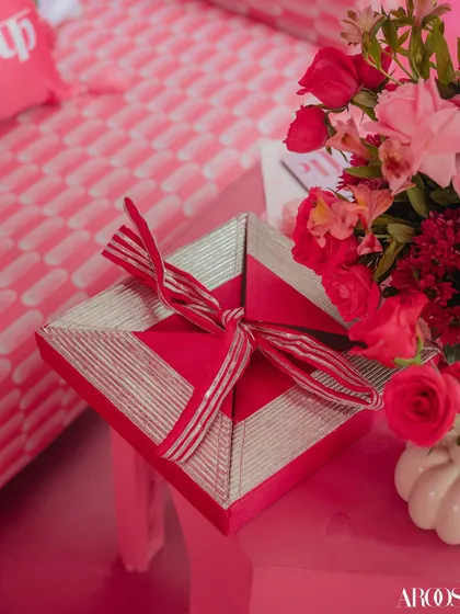 A beautifully wrapped favor box from the 'Gulabi Haldi', showcasing how even the smallest elements are designed to match the event's unique color palette and theme.