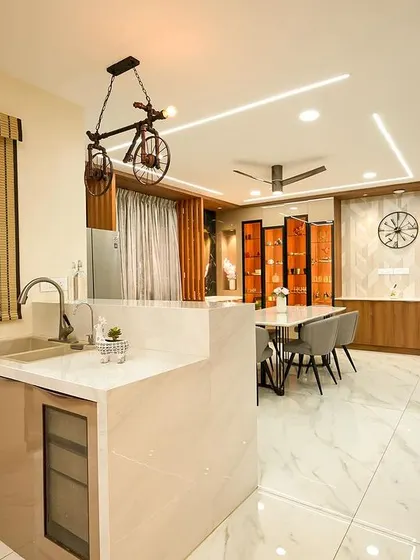 An open-concept view showing the kitchen, dining, and living areas of the villa. The design uses consistent materials and a cohesive color palette to create a seamless flow between the different functional zones.