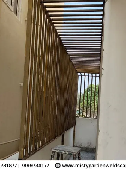 A metal fabrication project in progress. This structure with vertical slats is designed to provide privacy and security for a narrow balcony space.