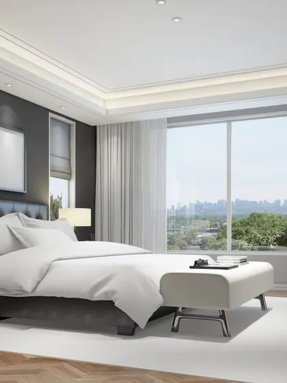 This spacious and bright master bedroom features a minimalist design with a dark accent wall, herringbone wood flooring, and large windows for ample natural light.