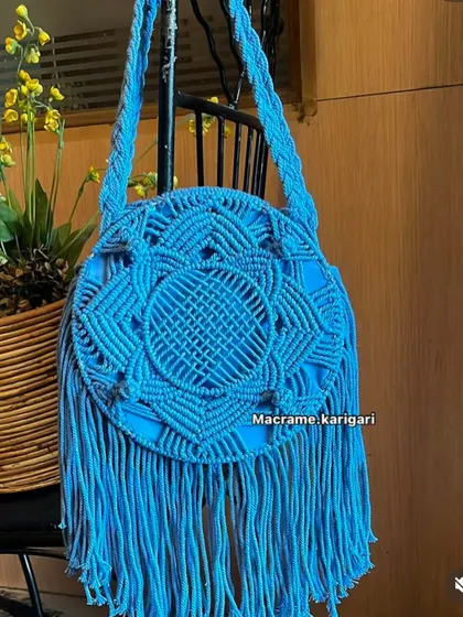 A beautiful example of a macramé bag, showcasing the intricate knotting techniques that differentiate it from crochet. We love working with both art forms.